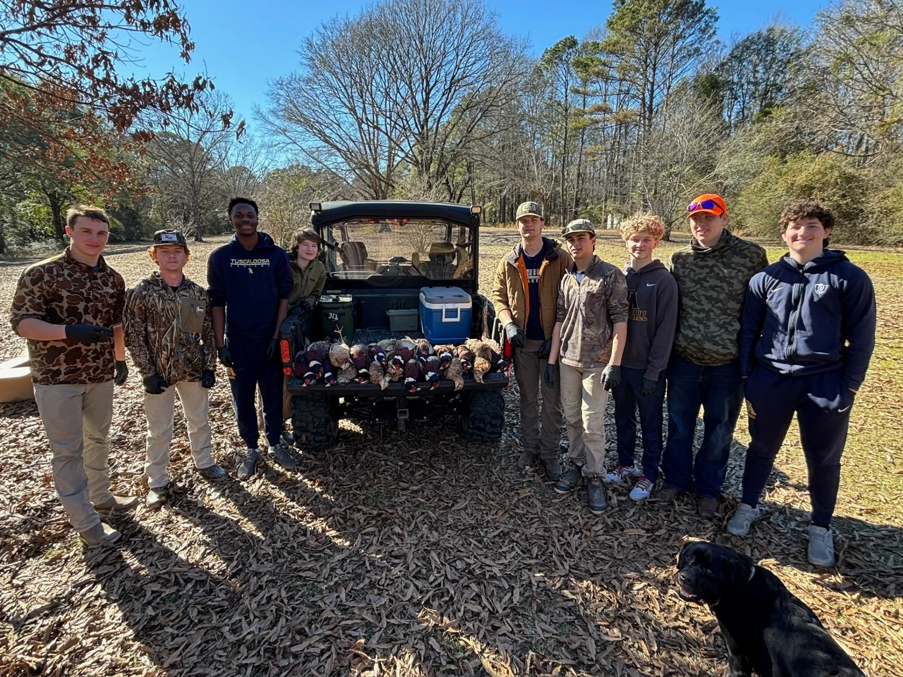 Student volunteers lined up behind the utility vehicle on event day