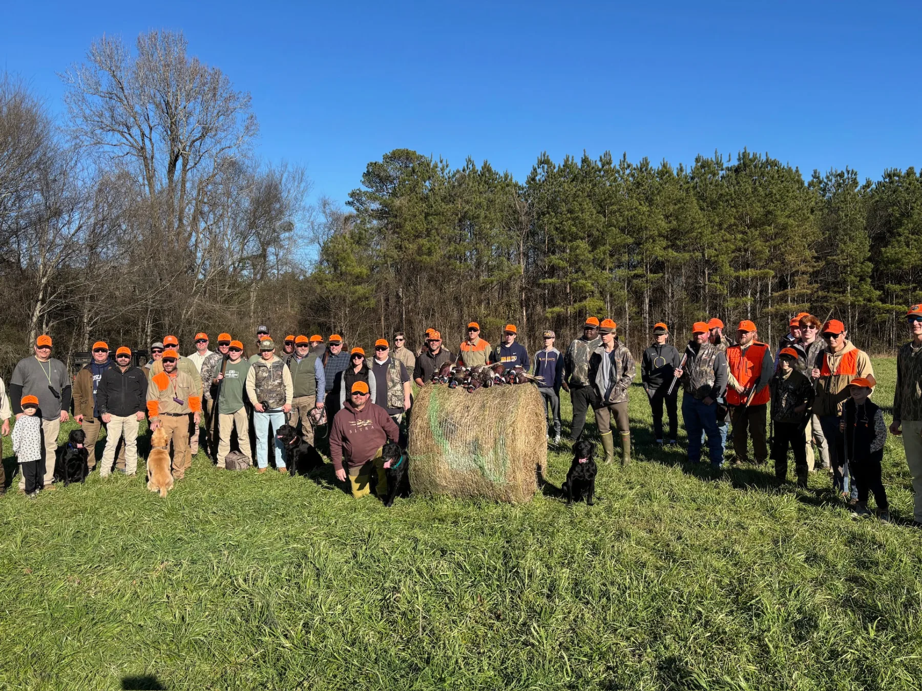 Participants, families and dogs gathered for the group photo at the shoot